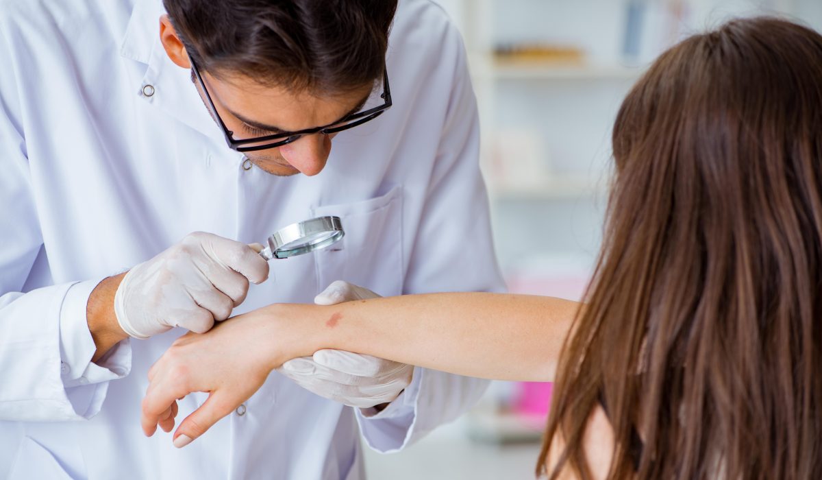 Doctor examining patient skin in hospital